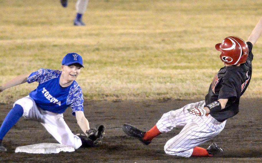 Nile C. Kinnick's Terrence Berg is about to be put out at second base as Yokota's Jeff Mullarkey gets set to apply the tag during the Red Devils' 9-2 victory in Tuesday's Kanto Plain baseball game.