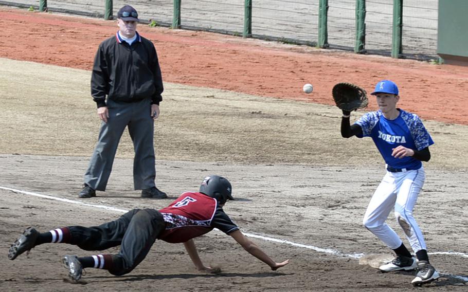 Yokota first baseman Luke Wiedie awaits the pickoff throw as Matthew C. Perry baserunner Justin Andres dives back to first during Saturday's DODEA-Japan baseball game. The Panthers routed the defending Far East Division II Tournament champion Samurai 16-0.