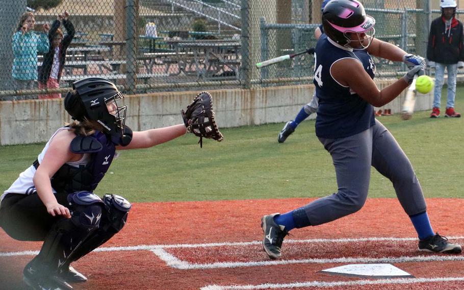 Seoul American's Krista Bradley connects with the pitch in front of Daegu catcher Ariel Lorts. The Warriors won Saturday's DODEA-Korea softball game 14-7.