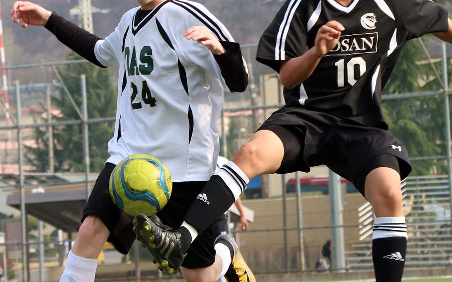 Daegu's Crandon Wolfgang and Osan's Grant Min battle for the ball during Thursday's Korea Blue boys soccer match. The teams played to a 1-1 draw.