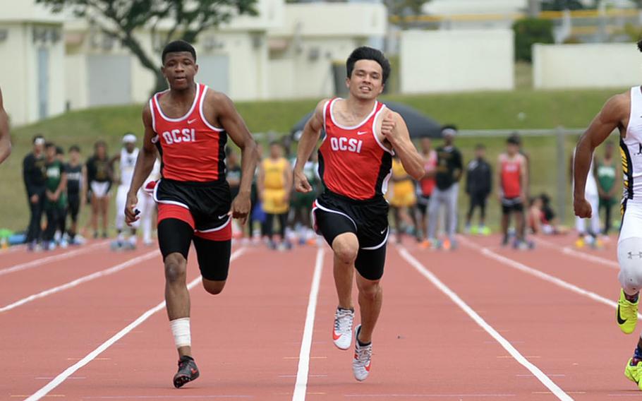 Nile C. Kinnick's Isaiah Brown, Okinawa Christian's Sam Calvin and Patrick Houston and Kadena's Eric McCarter head for the finish of the boys 100-meter dash during Friday's Mike Petty Memorial Track and Field Meet. McCarter won the 100 and the 200.