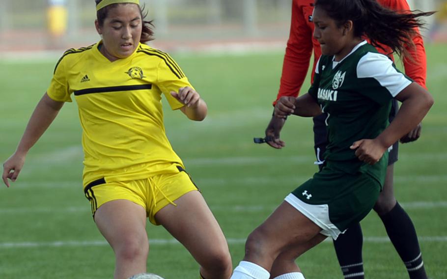 Kadena's Arisa Armel and Kubasaki's Chloe Ibarra battle for the ball during Saturday's Okinawa girls soccer match. The Panthers won 3-0.