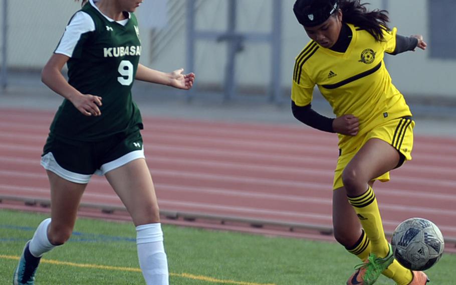 Kadena's Korina "Koko" Macato tries to play the ball next to Kubasaki's Natalie Mulherin during Saturday's Okinawa girls soccer match. The Panthers won 3-0.