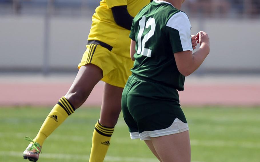 Kadena's Korina "Koko" Macato skies to head the ball over Kubasaki's Willow Lewis during Saturday's Okinawa girls soccer match. The Panthers won 3-0.