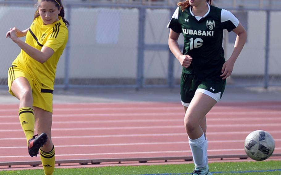 Kadena's Phoebe Bills sends a cross pass past Kubasaki's Abigail Robinson during Saturday's Okinawa girls soccer match. The Panthers won 3-0.