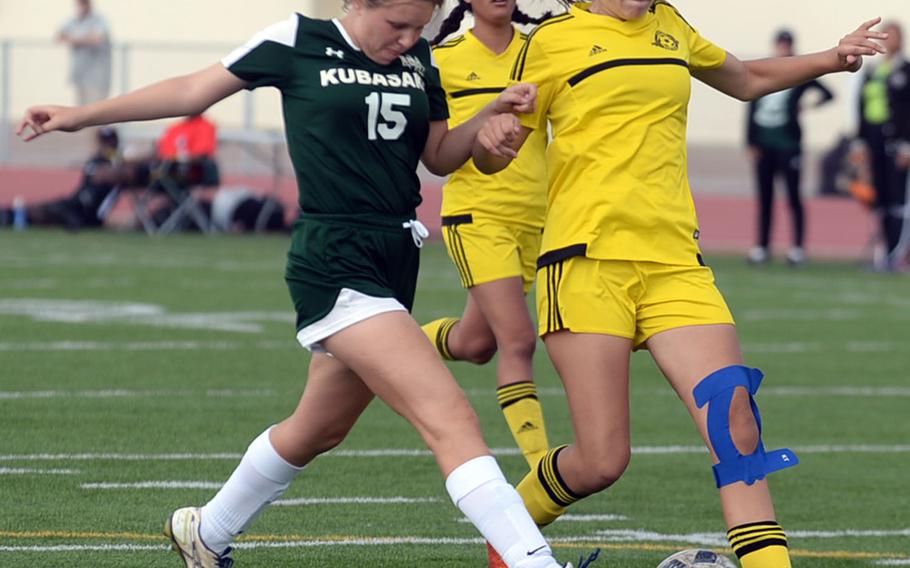 Kubasaki defender Hanna Ervasti and Kadena forward Megan Kirby chase the ball during Saturday's Okinawa girls soccer match. The Panthers won 3-0.