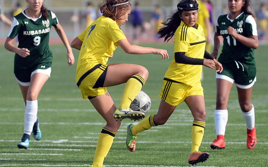 Kadena's Adrianna Gomez tries to settle the ball in front of teammate Korina "Koko" Macato as Kubasaki defenders Natalie Mulherin and Chloe Ibarra move up during Saturday's Okinawa girls soccer match. The Panthers won 3-0.