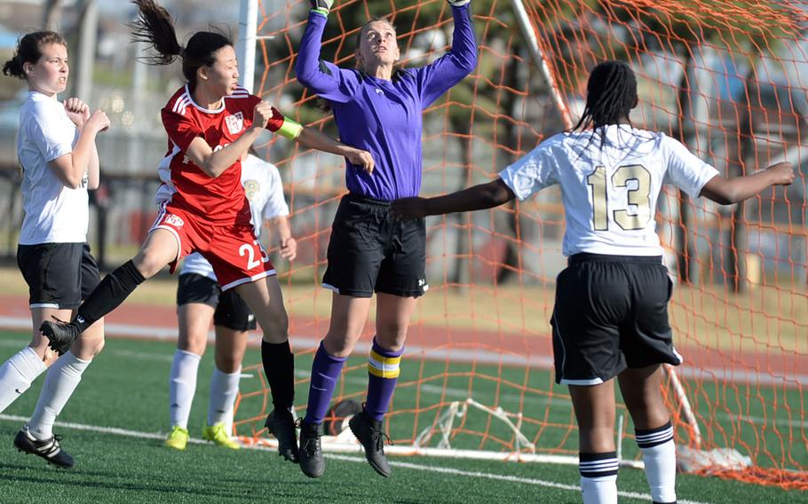 Humphreys goalkeeper Elayne Snyder leaps for a corner kick against Seoul Foreign during Wednesday's Korea Blue girls soccer match, won by the Crusaders 2-1.