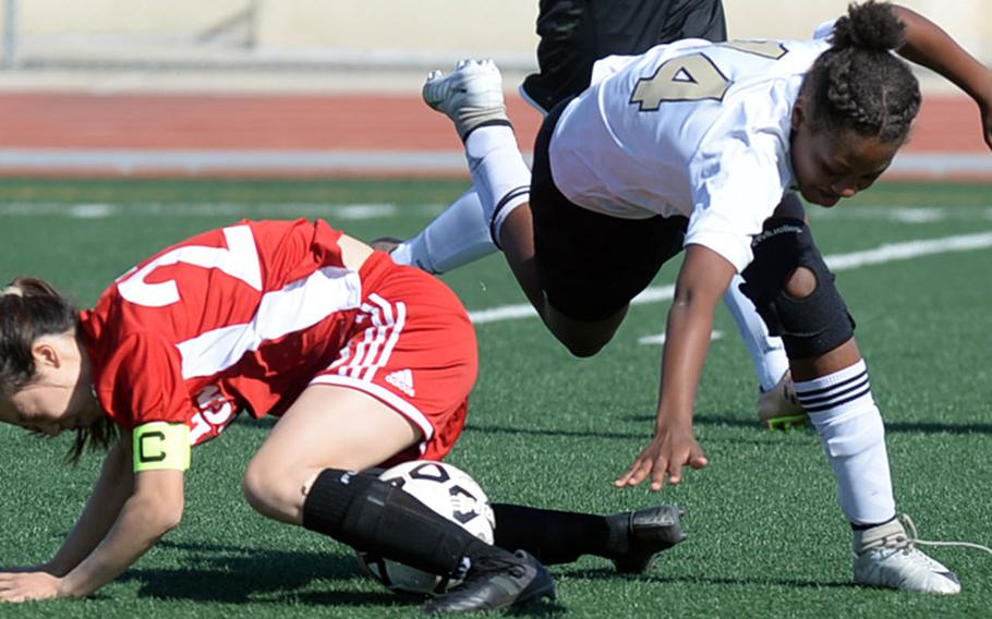 Seoul Foreign's Michelle Yun and Humphreys' Hayden McMillan tumble over the ball during Wednesday's Korea Blue girls soccer match, won by the Crusaders 2-1.