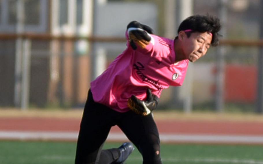 Looking every bit the baseball pitcher, Humphreys goalkeeper Jack Heo throws the ball against Seoul Foreign during Wednesday's Korea Blue boys soccer match, won by the Crusaders 9-2.