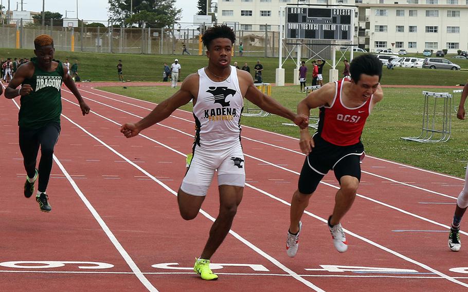 Kadena's Eric McCartercrosses the line first in the boys 100 during Saturday's Okinawa track and field meet at Kadena.