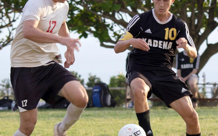 Okinawa Christian's Mark Lueder and Kadena's Kian Smith scuffle for the ball during Monday's boys soccer match, won by the Panthers 4-0.