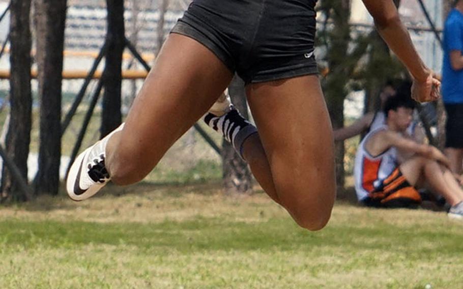 Seoul American senior Alyse Neal reaches the peak of her northwest Pacific record-breaking long jump of 5.70 meters, breaking a record set 12 years ago and matched in 2010. Neal also holds the Far East meet record of 5.30 set last season.
