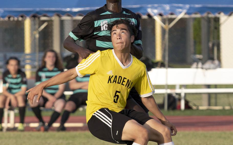 Nile C. Kinnick's Akimanzi Siibo and Kadena's Eric Fletcher ready to head the ball during Monday's round-robin play in the Far East Division I boys soccer tournament. The teams played to a 1-1 draw.
