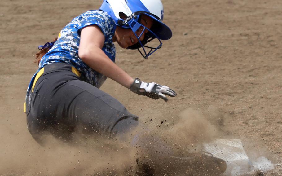 Yokota's Annalise Rodriquez slides into third base during Monday's round-robin play in the Far East Division II softball tournament. Yokota went 2-0-1 and earned the No. 3 seed into the double-elimination playoffs.
