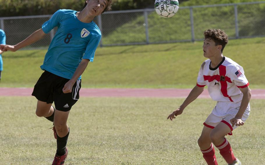 Kadena's Eric Fletcher heads the ball in Nile C. Kinnick's Cael Bowen's direction during Tuesday's semifinal match in the Far East Division I boys soccer tournament. The Panthers won 2-1 in extra time.
