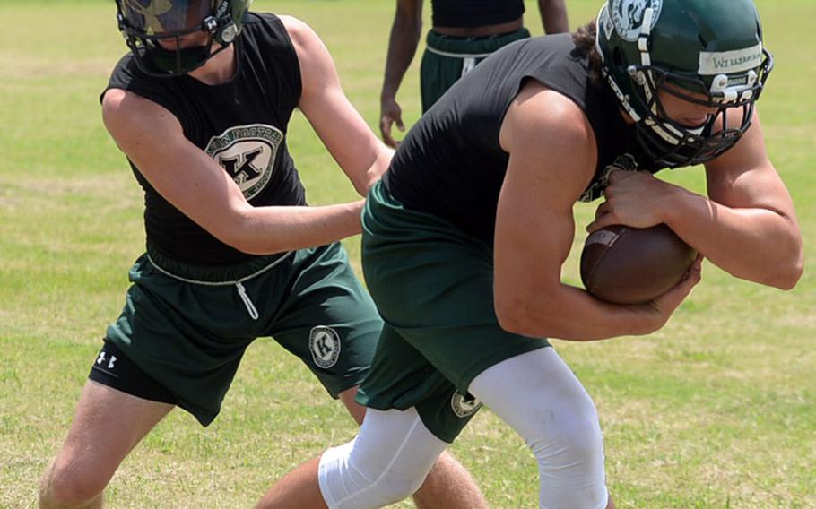 Senior quarterback Skyler Klimek hands off to senior fullback Hayden Williamson.