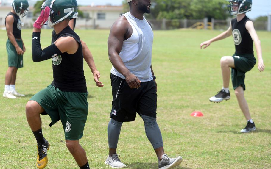 Jarrett Mitchell, Kubasaki Class of 2014 and the Dragons' all-time leading rusher, leads the team in warmups.