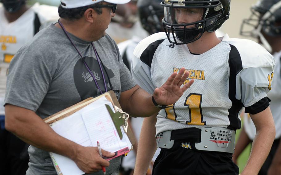 Coach Sergio Mendoza gives some pointers to his new quarterback, Wyatt Knopp.