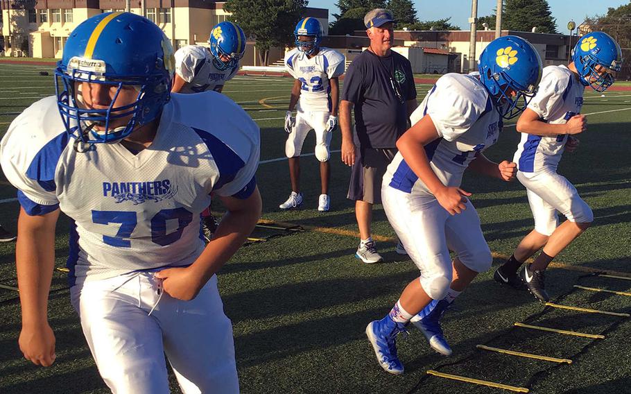 Yokota coach Tim Pujol casts a watchful eye during an agility drill during Tuesday's practice.