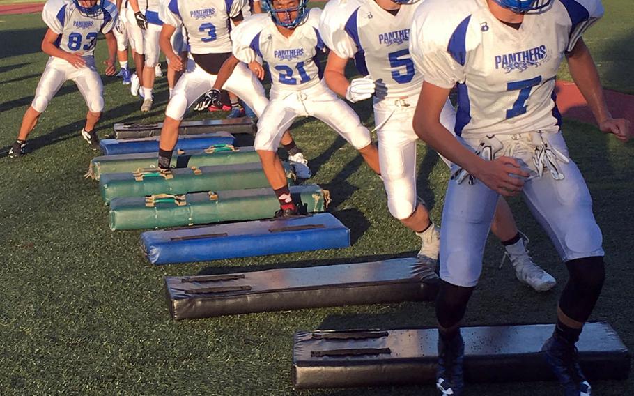 Seniors Eli Philliips and Ethan Gaume lead the way during a weave drill at Tuesday's Yokota practice.