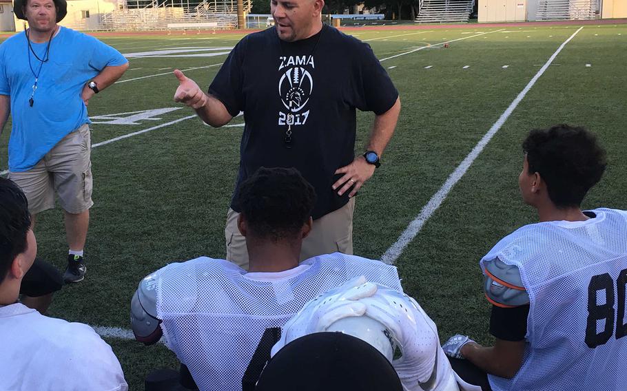 Zama coach Scott Bolin talks it over with his charges during a break in practice.