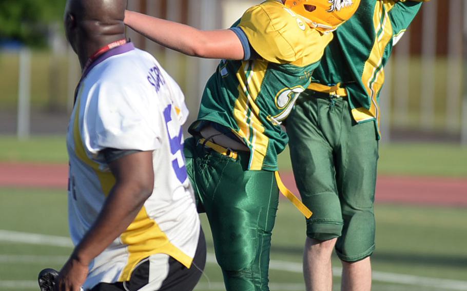 Eagles defenders Ethan Barry and Matthew Nichols go up for an interception under coach Jeremy Sanders' watchful eye.