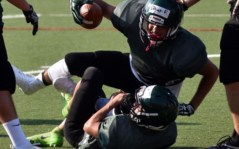 Daegu running back Ethan Rodriguez is taken down by defender Donald Thomas.