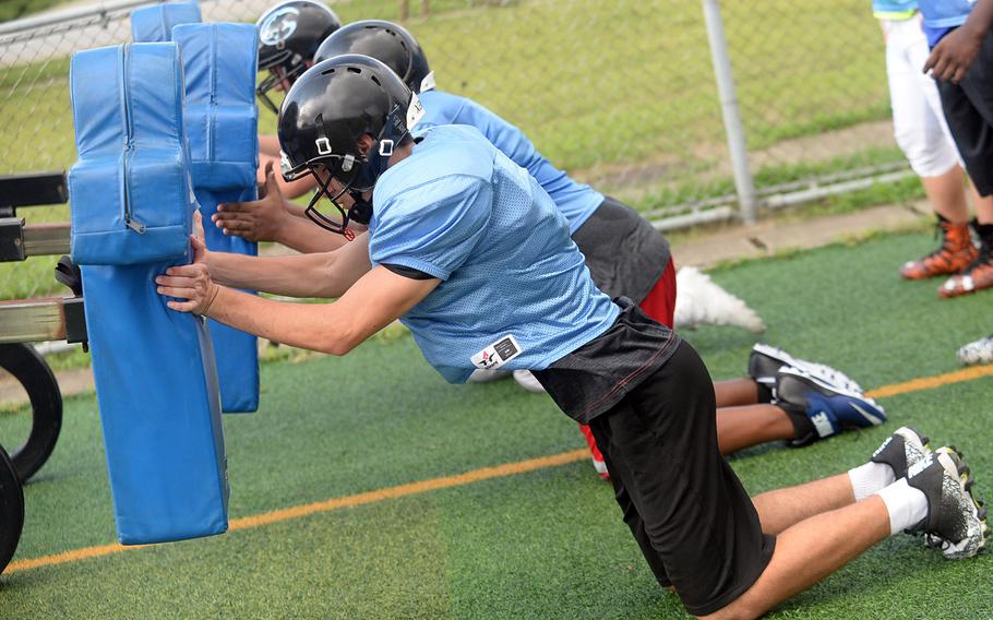 Osan's interior players take their cracks at the blocking sled.