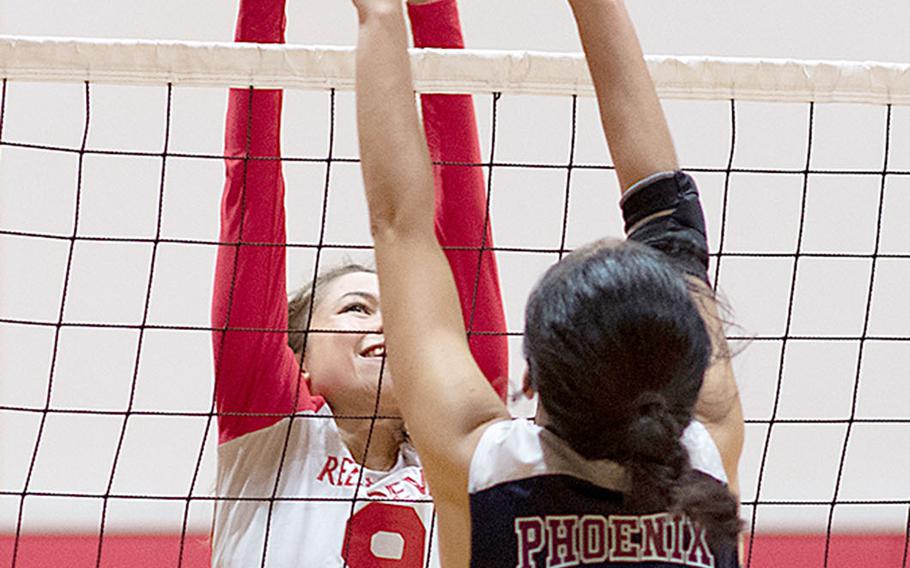 Nile C. Kinnick's Melissa Rose and Seisen International's Aimi Iwao battle at the net during Friday's rematch of last year's Far East Division I Tournament final. The Phoenix won this one also, 25-18, 25-23, 25-18 over the Red Devils.