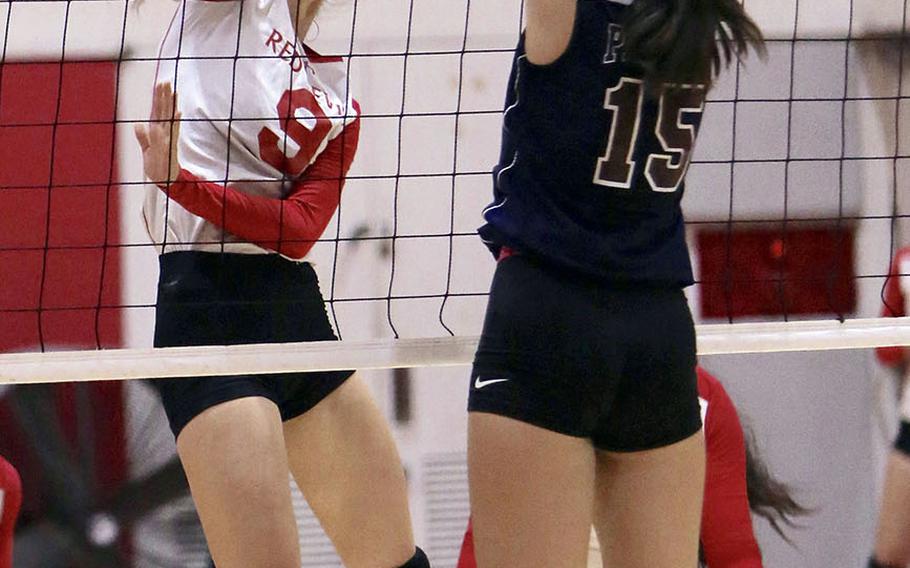 Nile C. Kinnick's Melissa Rose hits into the block by Seisen's Lilu Vandercamme during Friday's rematch of last year's Far East Division I Tournament final. The Phoenix won this one also, 25-18, 25-23, 25-18 over the Red Devils.