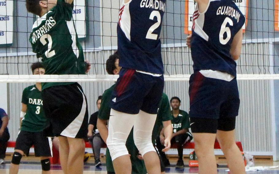Yongsan International-Seoul's Max Choi and Jacob Jeon battle Daegu's Aleiandro Jesus Miller for the ball during Saturday's Korea Blue boys volleyball match, won by the Guardians in three sets.                  