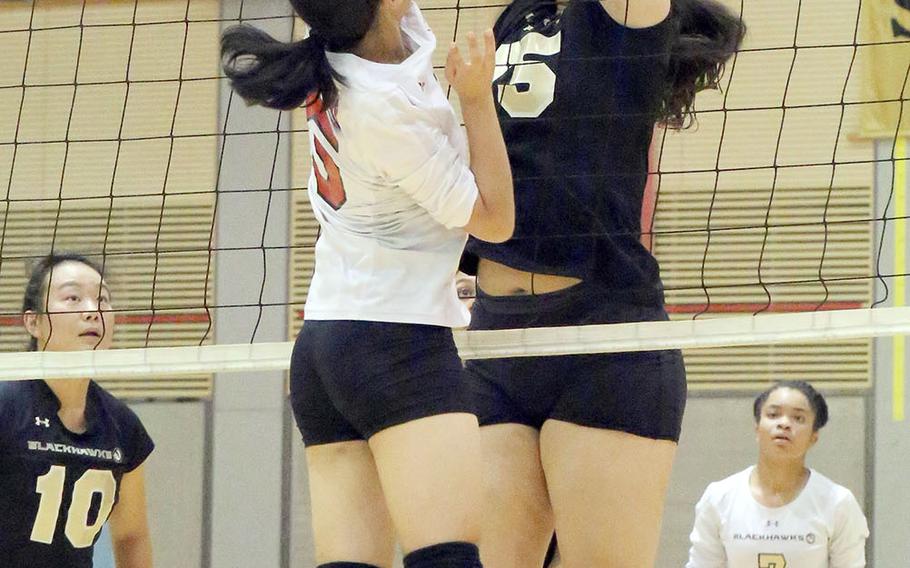 Humphreys' Raquel Barnes and Seoul Foreign's Eunice Chung go up for the ball at the net during Wednesday's three-set victory by the Crusaders over the Blackhawks.