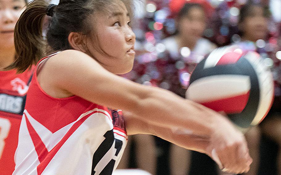 St. Maur's Renge Shirai bumps the ball against Nile C. Kinnick during Wednesday's three-set victory by the Red Devils over the Cougars.