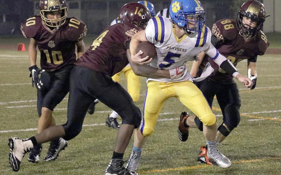 Yokota's Ethan Gaume drags Matthew C. Perry defenders Micah Rupp and Robert Rogers, with Roy Clayton in trail.