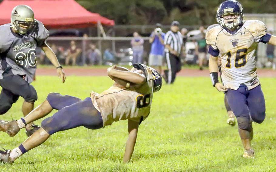 Guam High quarterback RaSean Jacobs tumbles into the end zone between teammate Drew Mestas and Simon Sanchez's Dylan Cabe.