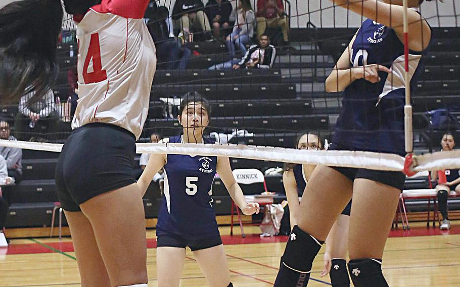Sacred Heart's Karin Kosugi has a shot blocked by Nile C. Kinnick's Francine Gemeniano during Thursday's three-set win by the Red Devils over the Symbas.