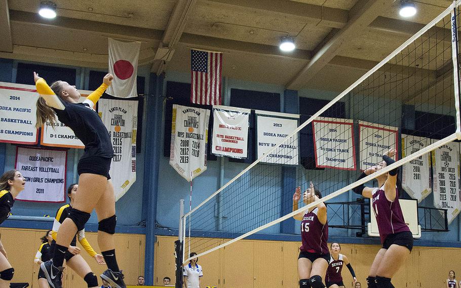American School In Japan's Kennedy Baca gets set to hit against two Seisen blockers during Saturday's four-set win by the Phoenix over the host Mustangs.