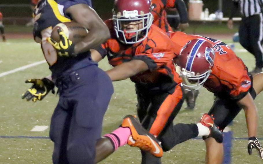 Guam High's Jeylyn Dowdell outraces a pair of Okkodo defenders.