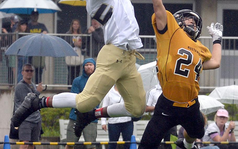 Humphreys' Junior Gregory leaps for a touchdown catch over American School In Japan defender Tei Laughlin.