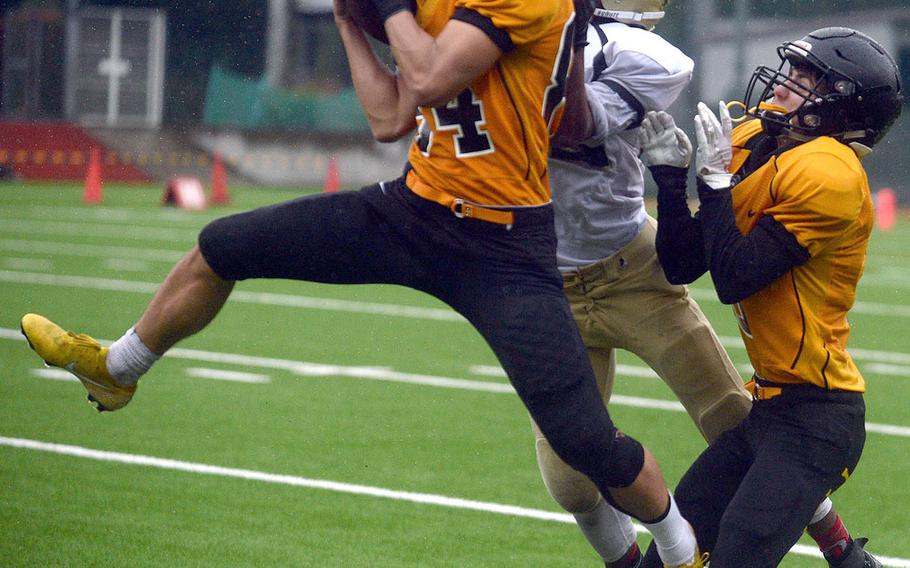 American School In Japan's Tyler Cross grabs one of his two interceptions vs. Humphreys.