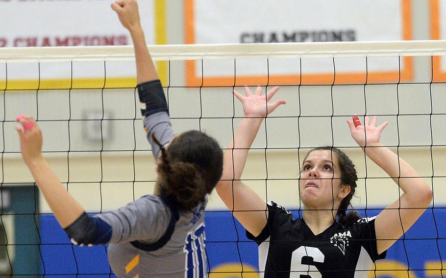Yokota's Adrianna Diaz and Zama's Amelia Young battle at the net for the ball during Tuesday's three-set win by the Trojans over the Panthers.