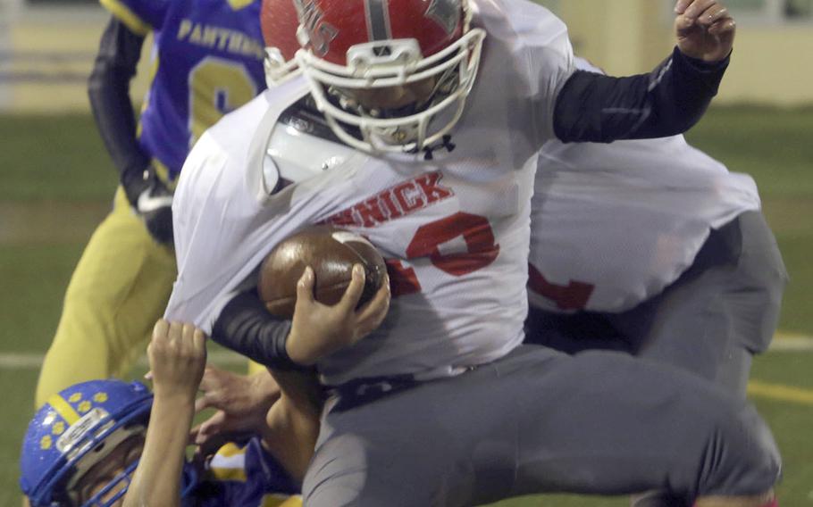 Nile C. Kinnick running back Liam Barrera is wrestled down in the end zone. He scored on the play.