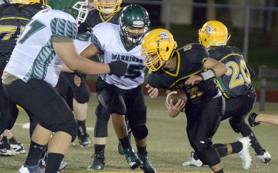 Daegu's Andrew Neloms and Jacob Berry close in on Robert D. Edgren quarterback Raphael Lykins.