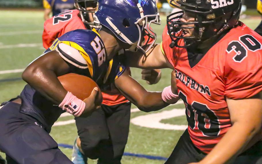Guam High's Jeylynn Dowdell tries to fight his way through Southern's Isaiah Castro and Isiah Topasna.