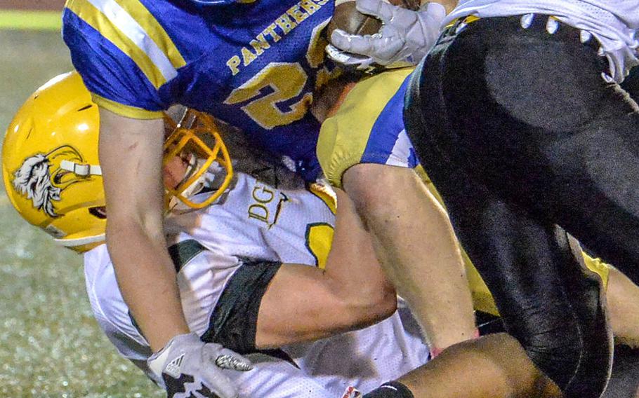 A Robert D. Edgren defender hauls down Yokota running back Ethan Smith.