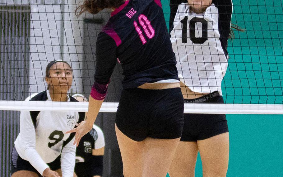 Yokota's Adrianna Diaz and Zama's Leah Sakamoto-Flack battle at the net during the Panthers' two-set win Friday in the 4th American School In Japan YUJO Tournament.