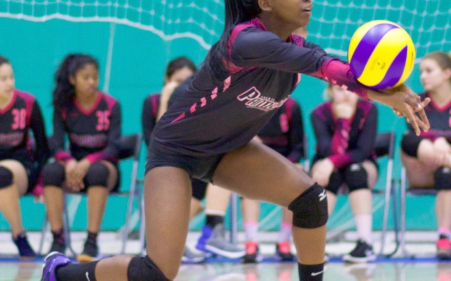 Yokota's Haley Singleton bumps the ball during Friday's two-set loss to United World College of Singapore in the 4th American School In Japan YUJO Tournament.