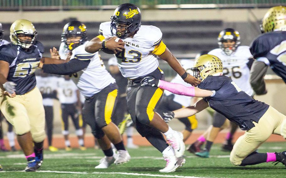 Kadena running back Uriah Morris breaks a tackle for a long run against Humphreys durring a football game at Camp Humphreys, South Korea, Saturday, Oct. 13, 2018.