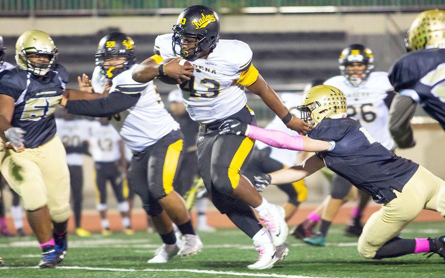 Kadena running back Uriah Morris breaks a tackle for a long run against Humphreys durring a football game at Camp Humphreys, South Korea, Saturday, Oct. 13, 2018. 